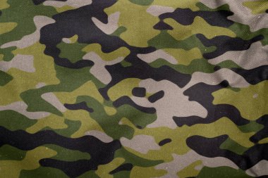 Açık hava kamuflaj örgüsü, askeri branda deseni, kamuflaj kumaşı dokusu, ordu tuvali arka planı.
