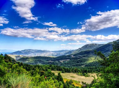 Country land under blue cloudy sky