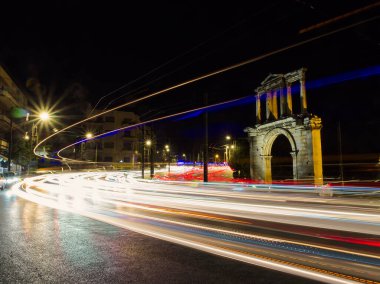 Light trails of moving cars under Hadrian Arch Temple of Olympian Zeus, Athens, Greece