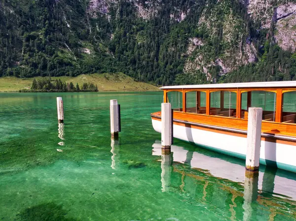 Touristic boat floating over clean Konigssee lake waters. Bavaria, Germany