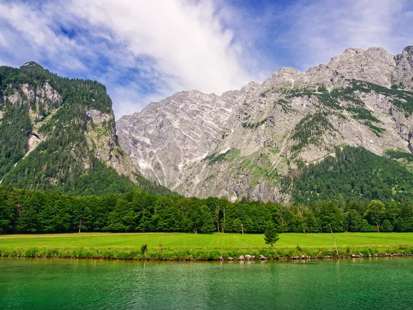 Mountain view and grass area next to the Konigssee lake. Bavaria, Germany