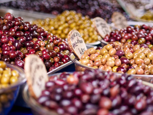 Greek olives for sale close-up in street market stall. High quality photo