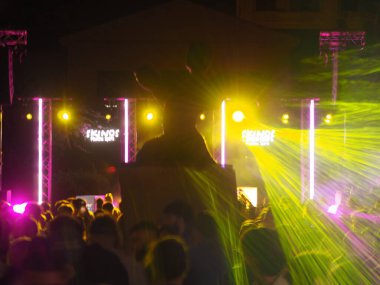 Atina, Yunanistan - 4 Mayıs 2025: Renkli lazer ışıkları, dans eden insanların siluetleri ve Atina Festivali 'nde ışıklandırılmış sahne kurulumu ile kalabalık parti