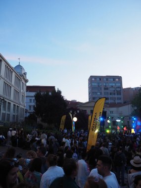 Atina, Yunanistan - 4 Mayıs 2025: 2025 Atina Şehir Festivali sırasında binalar ve renkli ışıklarla dolu bir sokaktaki kalabalık