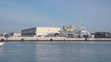 Venezia , Italy - 30 august 2022 : Taxi Boat Operating around Industrial Port with Crane. High quality 4k footage