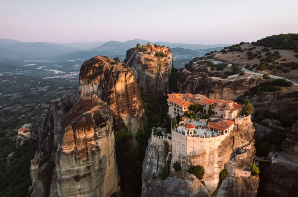 stock image Aerial view of monasteries Trinity and breathtaking pictures of valley and landmark canyon of Meteora at sunset, Kalambaka, Greece, shadows, twisted road, bridge, Mountains as columns