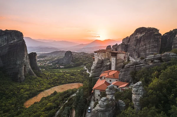 stock image Aerial view of monasteries Trinity and breathtaking pictures of valley and landmark canyon of Meteora at sunset, Kalambaka, Greece, shadows, twisted road, bridge, Mountains as columns