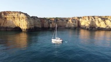 Full HD Aerial Drone Sunrise Sunset view of Ponta de Piedade, point of mercy, in Algarve Faro Portugal. High quality FullHD footage, with a boat on the foreground