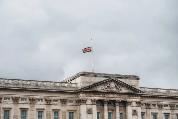 England mourning, half raised flag Union Jack on Buckingham Palace London UK. High quality photo United Kingdom