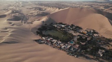 Huacachina, Ica, Peru, Güney Amerika 'da çölün, kum tepelerinin, mitinglerin ve böceklerin 4K hava aracı içeriği. Yüksek kalite 4k görüntü