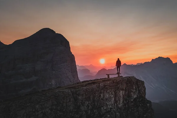 Silhouette of a person during a morning sunrise in the mountains of Italy. High quality photo