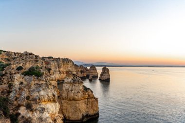 Lagos, Algarve, Portekiz 'de güneş doğarken Ponta da Piedade' nin harika manzarası. Yüksek kalite fotoğraf