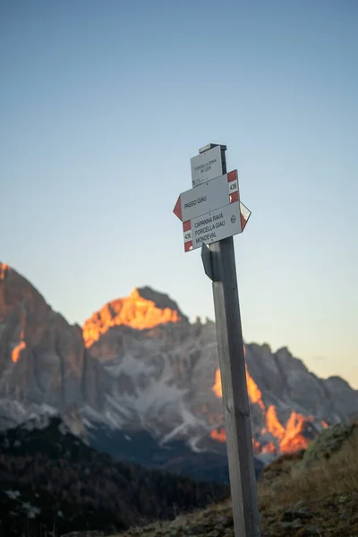 Sunset photo of hiking sign on mountain trail, Passo Giau in Dolomites, Italy. High quality photo