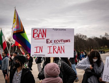 a guy holding a sign support  at a protest