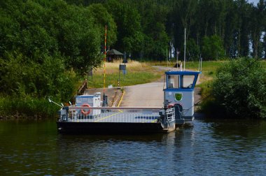 Ferry on the River Weser in the Village Schweringen, Lower Saxony clipart