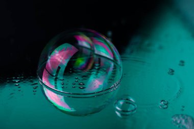 Ayna yüzeyinde su damlaları olan parlak gökkuşağı renkli, şeffaf, şeffaf, parlak, parlak dokular. Kartvizit etiketleri için başlık işaretleri için el ilanları