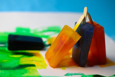 bright sweet iridescent chilled ice cream on a stick on a colored background with iridescent drops for labels splash screens signage banners flyers flyers menu announcements