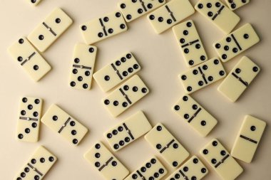 Tüm aile ve domino oyuncuları için mantık oyunu. Açık renkli domino taşlarının üzerinde siyah noktalar var.