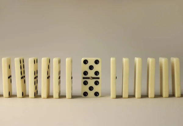 stock image board logic game for the whole family and friends of dominoes. light-colored dominoes with black dots on a light and mirror background