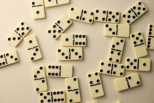 board logic game for the whole family and friends of dominoes. light-colored dominoes with black dots on a light and mirror background