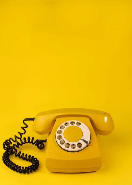 stock image yellow bright retro telephone on a bright yellow background. for banners, advertisements, flyers, screensavers, covers, invitation cards, etc.
