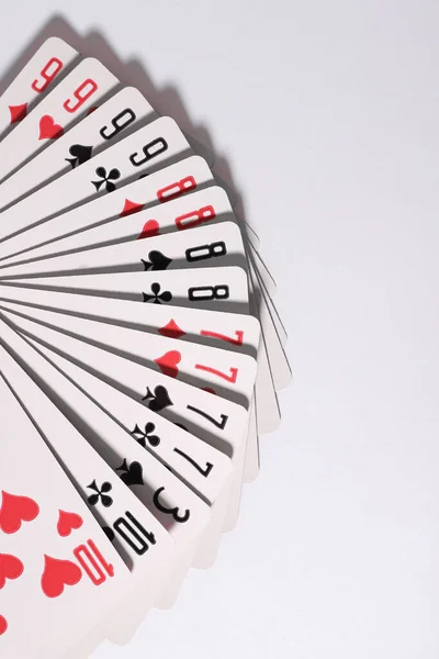 card gambling. a deck of cards fanned out on a white background