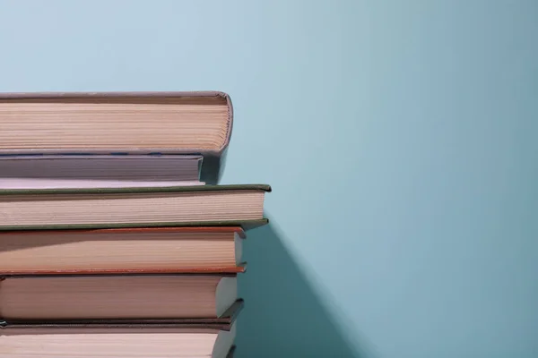 Stack of books on a light blue background