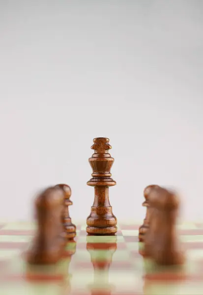 logic game of chess. on the chessboard in the center of attention is the figure of the king and around the rest of the chess pieces