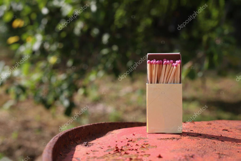 Matchbox on red old iron background. matches with pink sulfur