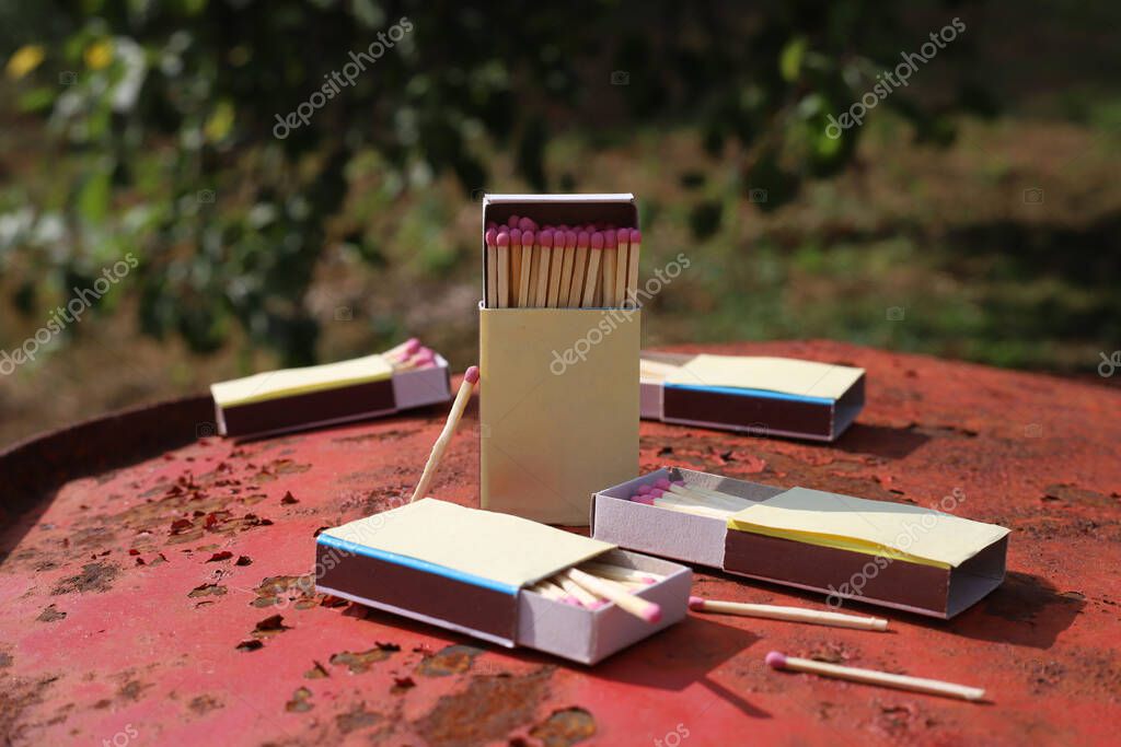 Matchbox on red old iron background. matches with pink sulfur
