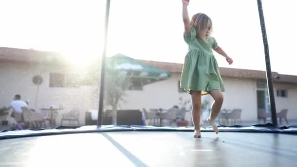 Young Girl Green Dress Standing Trampoline Leisurely Enjoying Sky Trees — Stock Video