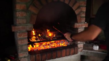 Aşçı ızgarada eti maşayla pişiriyor. Yüksek kalite 4k görüntü
