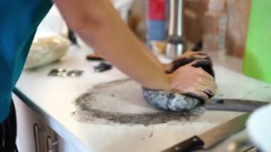 Housewife kneading black dough on the table. High quality 4k footage