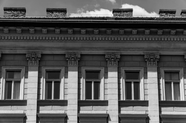 an old building with shadows and chimneys, photographed horizontally in black and white