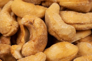 A pile of roasted and salted cashews isolated.
