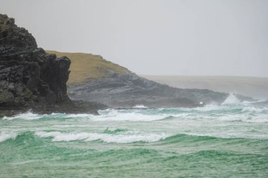 Waves crash onto empty Eoropie Beach on the Isle of Lewis, Scotland with bad weather. clipart