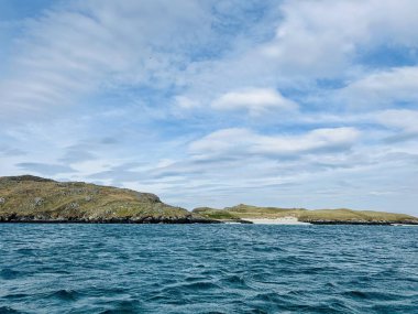 Beautiful Loch Rog with turquoise lagoon waters surrounding Pabaigh Mor island. Paddling around Scottish Outer Hebrides islands. High quality photo clipart