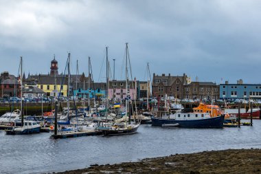 Boats in Stornoway fishing harbour, Isle of Lewis, Outer Hebrides, Scotland, on a wet, grey, day.  clipart