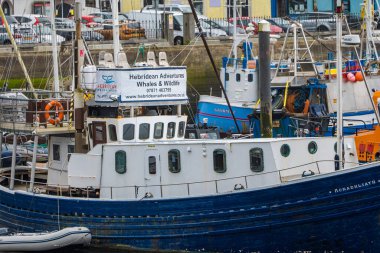 Boats in Stornoway fishing harbour, Isle of Lewis, Outer Hebrides, Scotland, on a wet, grey, day.  clipart