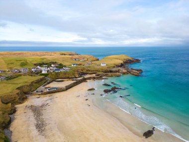 Aerial drone view of Port of Ness on the Isle of Lewis in the Outer Hebrides. Beautiful landscape of beach and sea on sunny day. clipart
