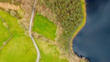 Swinsty Reservoir and surrounding winding countryside road in North Yorkshire clipart