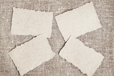 Yırtık kenarlı el işi kağıtları çuval bezinin arka planında, kopyalama alanı