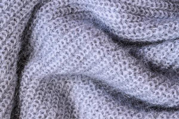 Close up background of knitted wool fabric, blue knitting wool knitwear texture. Knitted fluffy yarn, abstract backdrop