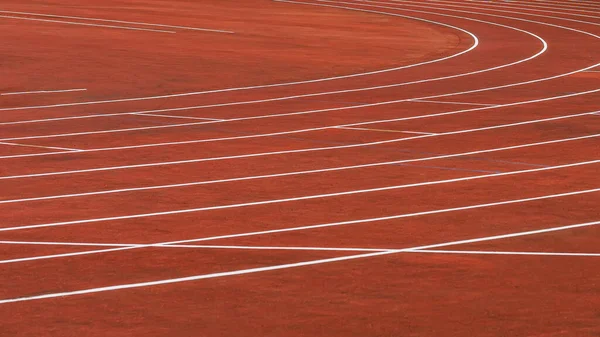 Red running tracks in sport stadium outdoors, background and texture. Sport concept