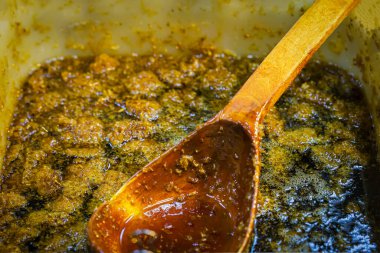 Kalın ballı perga, tahta kaşıkla yakın plan. Arı ekmeği ve kraliyet jölesi ile karıştırılmış bal, sağlıklı gıda konsepti, diyet