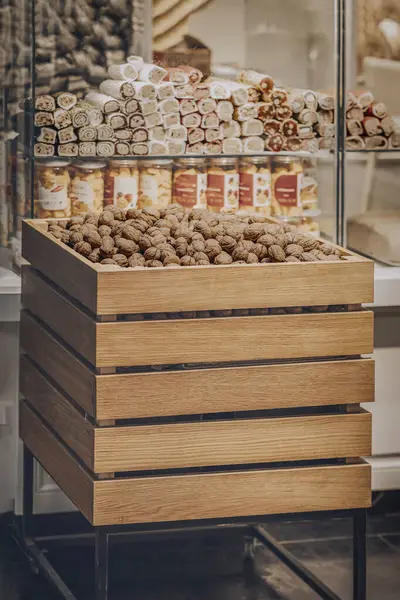 Wooden box with walnuts in the department of a grocery store. Healthy sweets and snacks concept