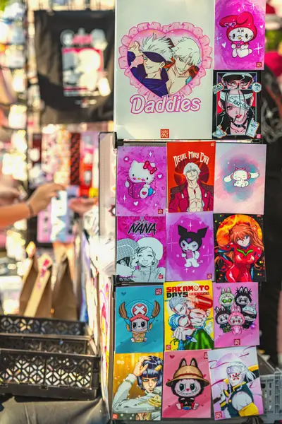 Hello Kitty, Devil May Cry ve diğer pop ikonlarının yer aldığı anime temalı posterlerle dolu parlak dikey ekran. Anime duvar sanatı kavramı, canlı posterler, fanatik koleksiyonlar.