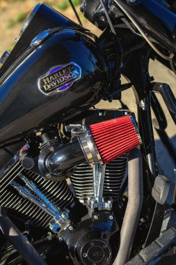 BURGAS, BULGARIA - 21 SEPTEMBER, 2025: Close-up of Harley Davidson motorcycle engine with red air filter, chrome details under sunlight. Concept of motorcycle power, mechanical precision, custom style