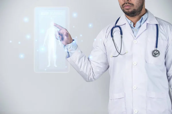 Doctor with stethoscope pointing at digital x-ray image of human body