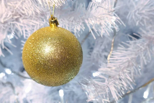A Shiny gold and silver christmas spheres on christmas tree with space for text